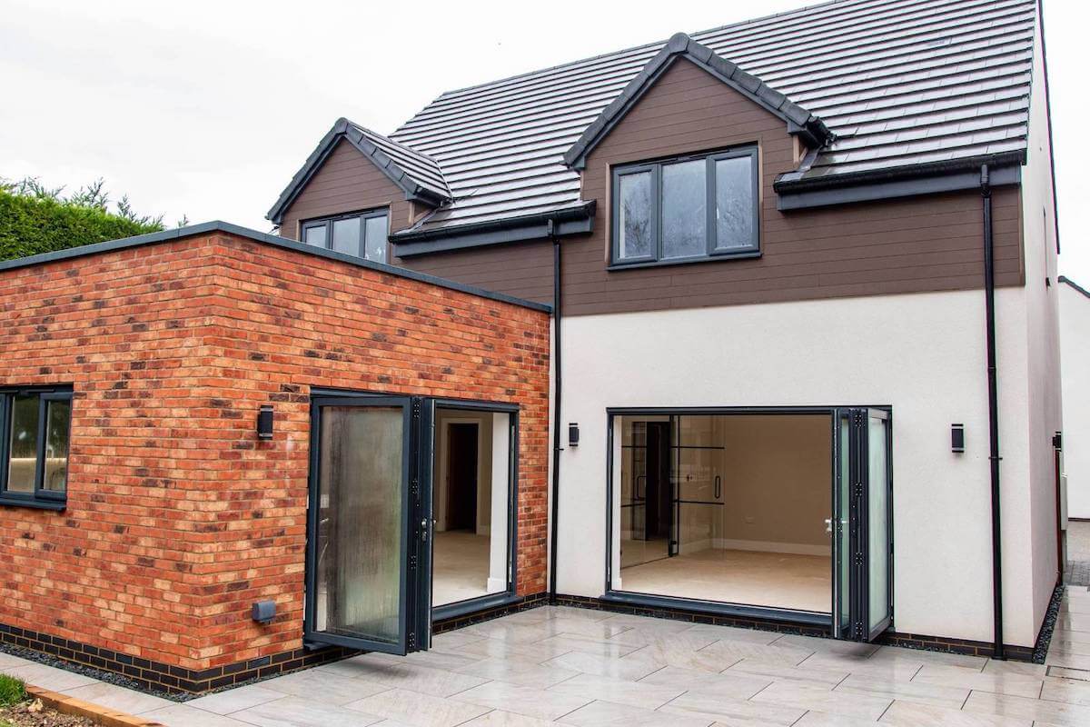 Modern brick extension with large bifold doors and windows on a new home.