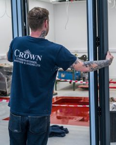 crown worker installing bi-fold door