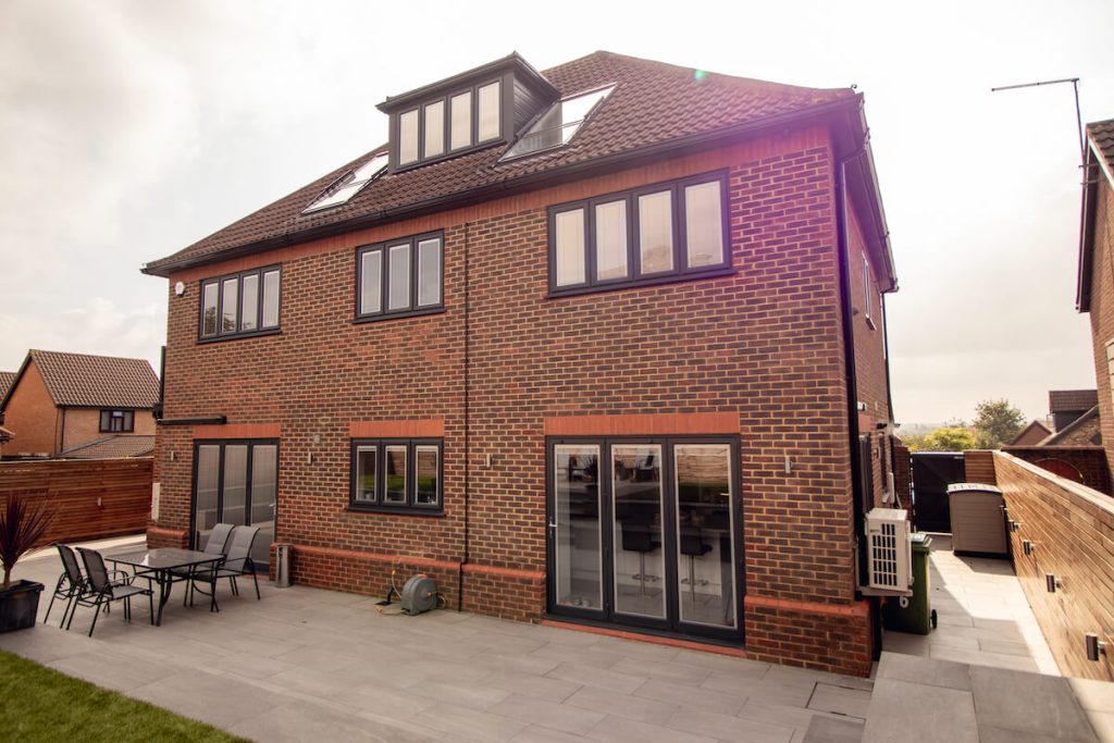 rear of house with new black windows and bi-fold doors