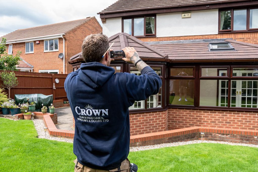 crown worker taking photo of conservatory